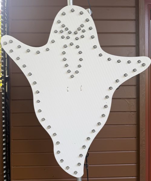 Front of a ghost-shaped prop with pixels forming its face and outline