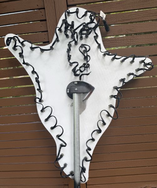 Back of a ghost-shaped prop showing the pixel wiring looped around its outline
