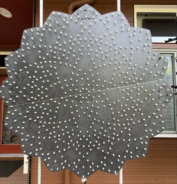 Front of a large starburst prop with hundreds of pixels set into the panel