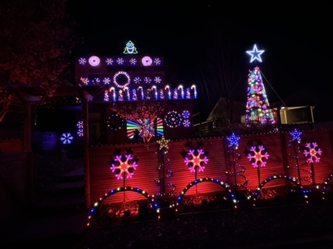Christmas display with pink snowflakes and a rainbow mega tree