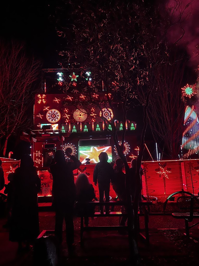 Guests watching the Christmas display glowing red from the bench out front